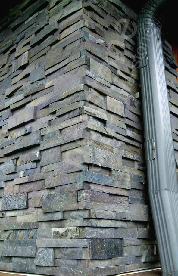 Norstone Charcoal Rock Panels showing vertical corner along side of house with rain downspout